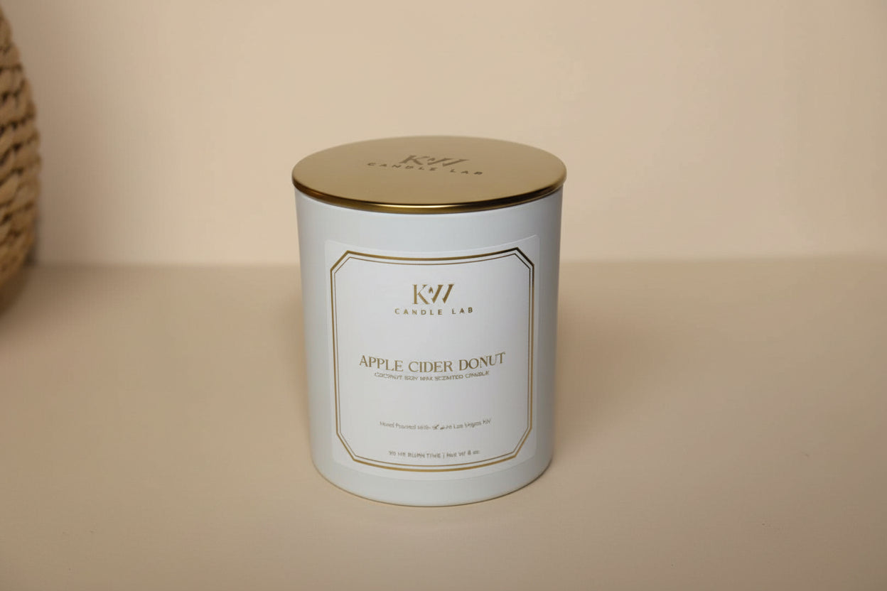 picture of a white candle with a gold lid with kw candle lab logo engraved in the lid