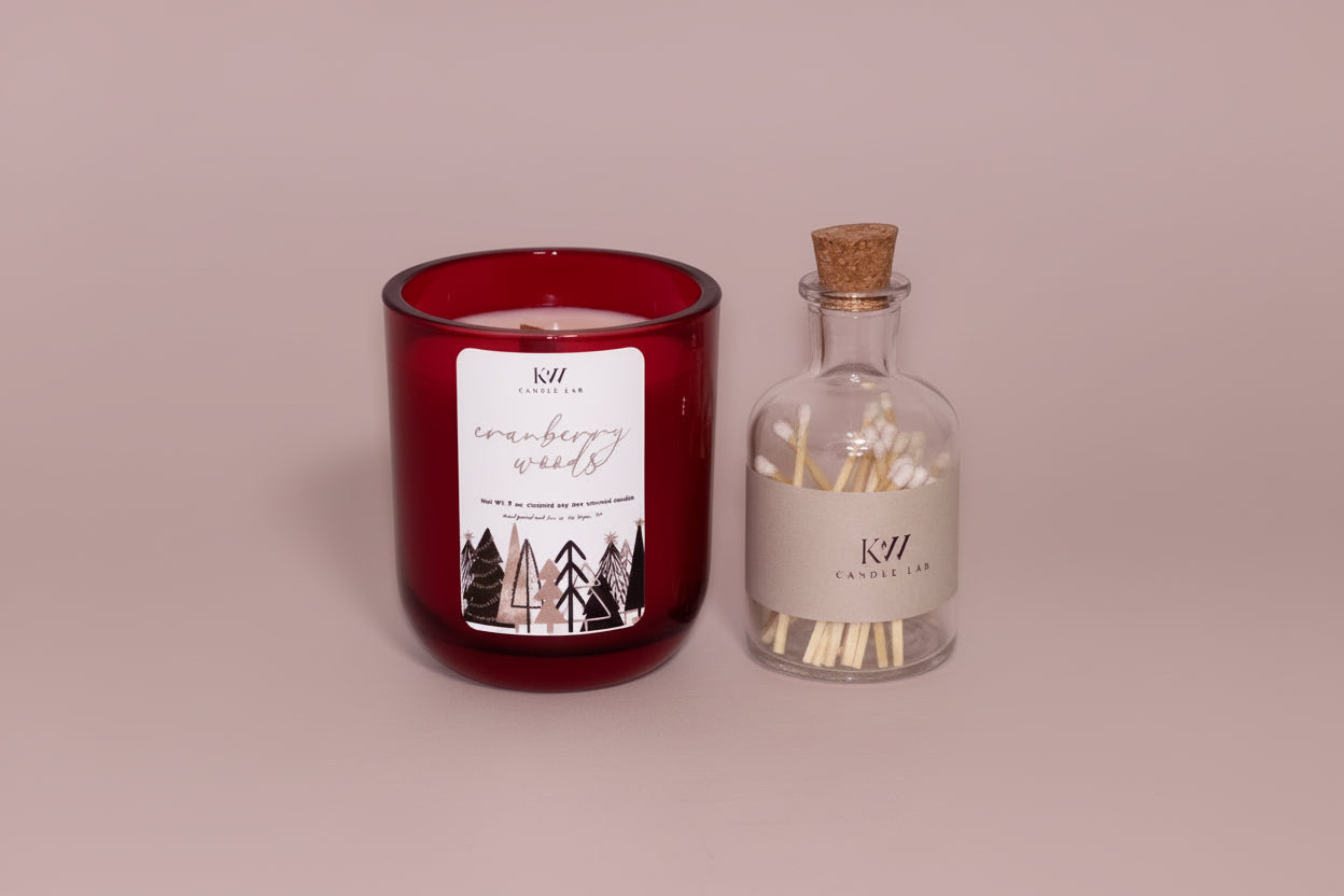 kw candle lab cranberry woods scented candle jar and matches on a pink background