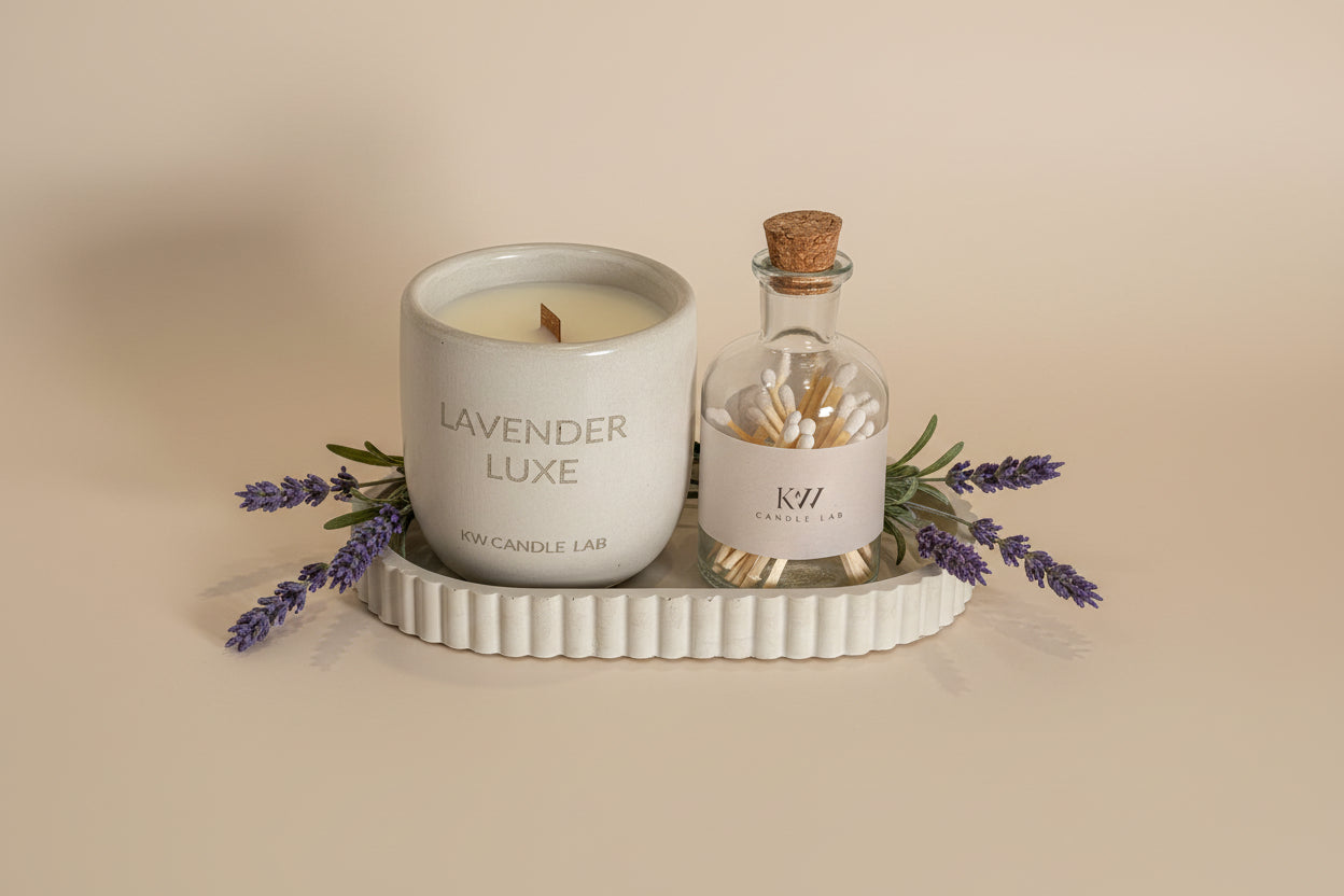 kw candle lab hand made concrete jar candle in lavender luxe scent on a concrete tray along side a bottle of matches